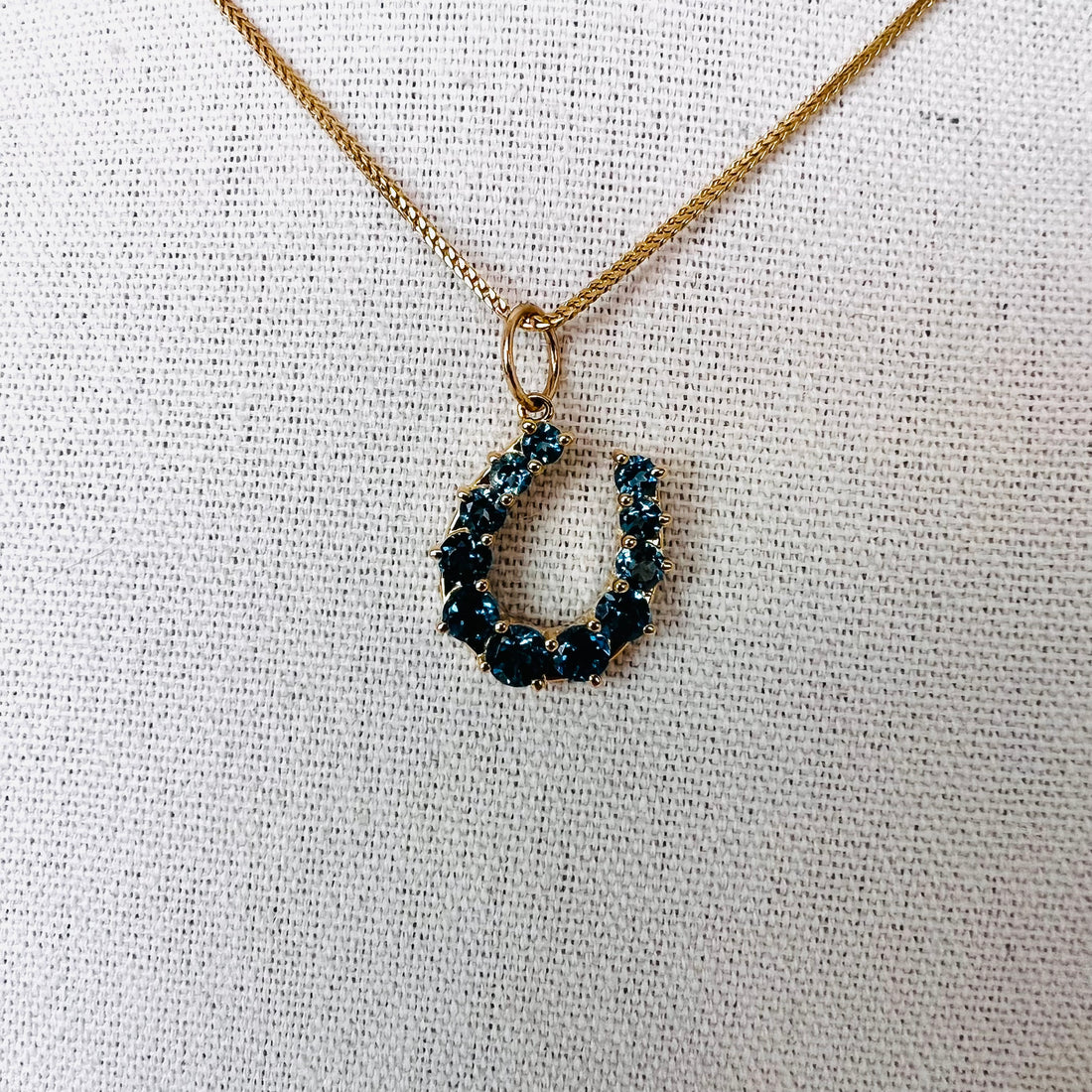 14k gold and London blue topaz horseshoe pendant