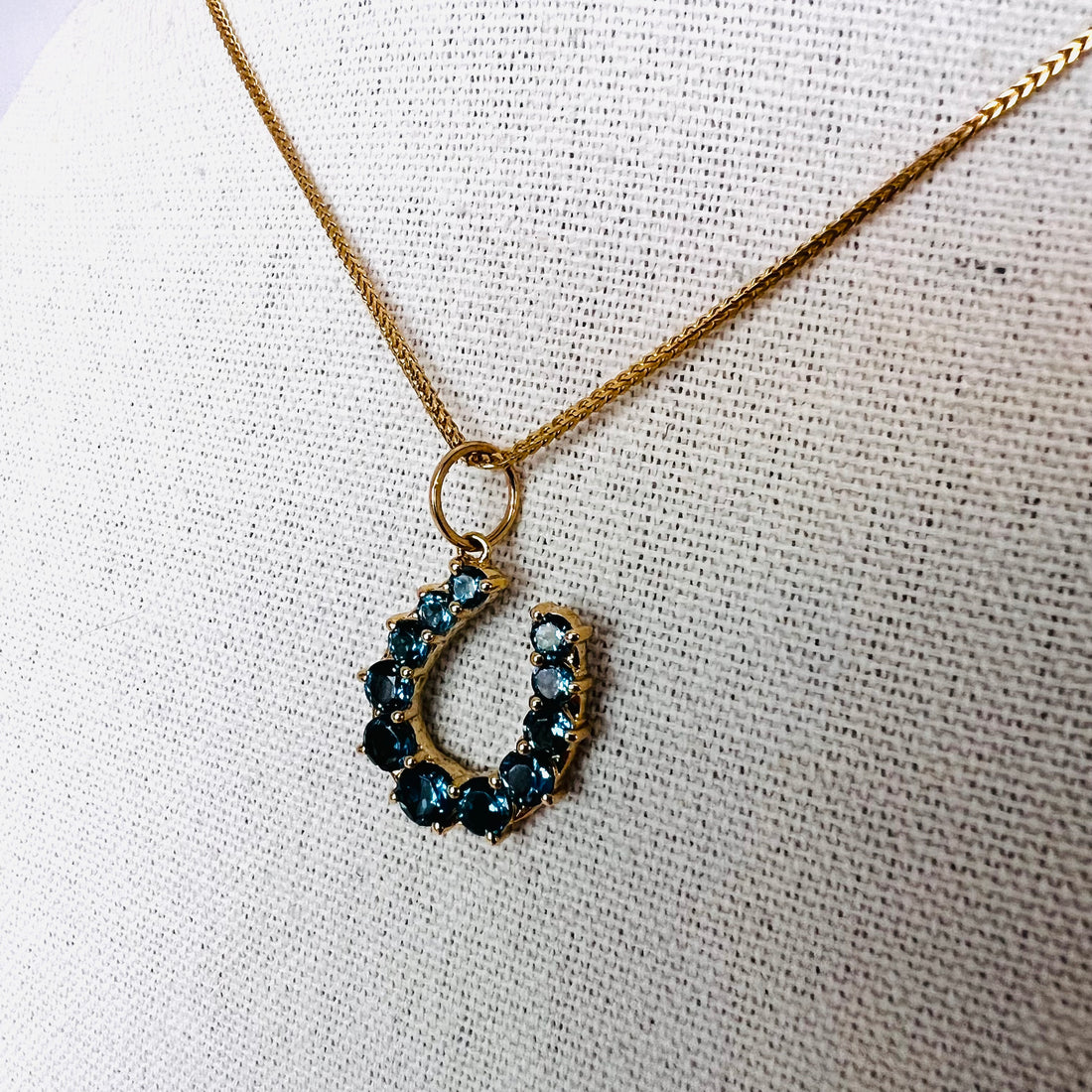 14k gold and London blue topaz horseshoe pendant