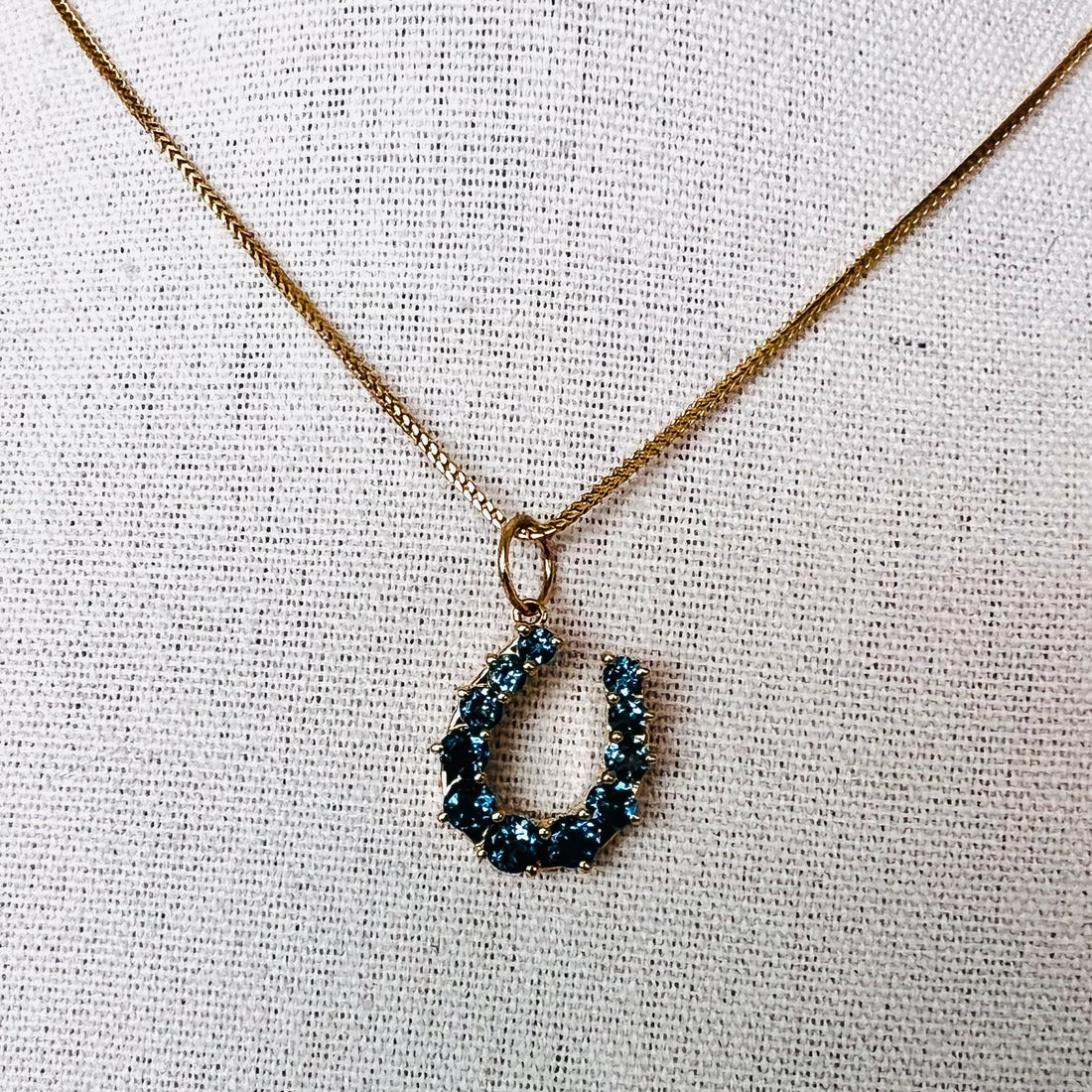 14k gold and London blue topaz horseshoe pendant