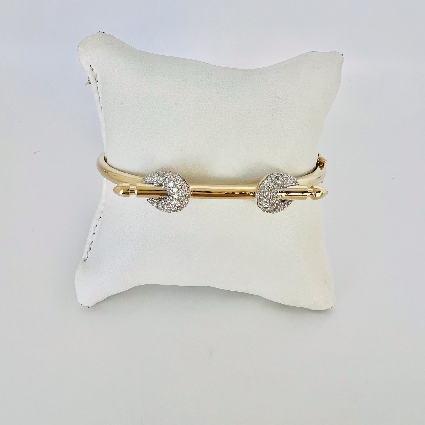 14k gold and baguette bangle with two diamond knots
