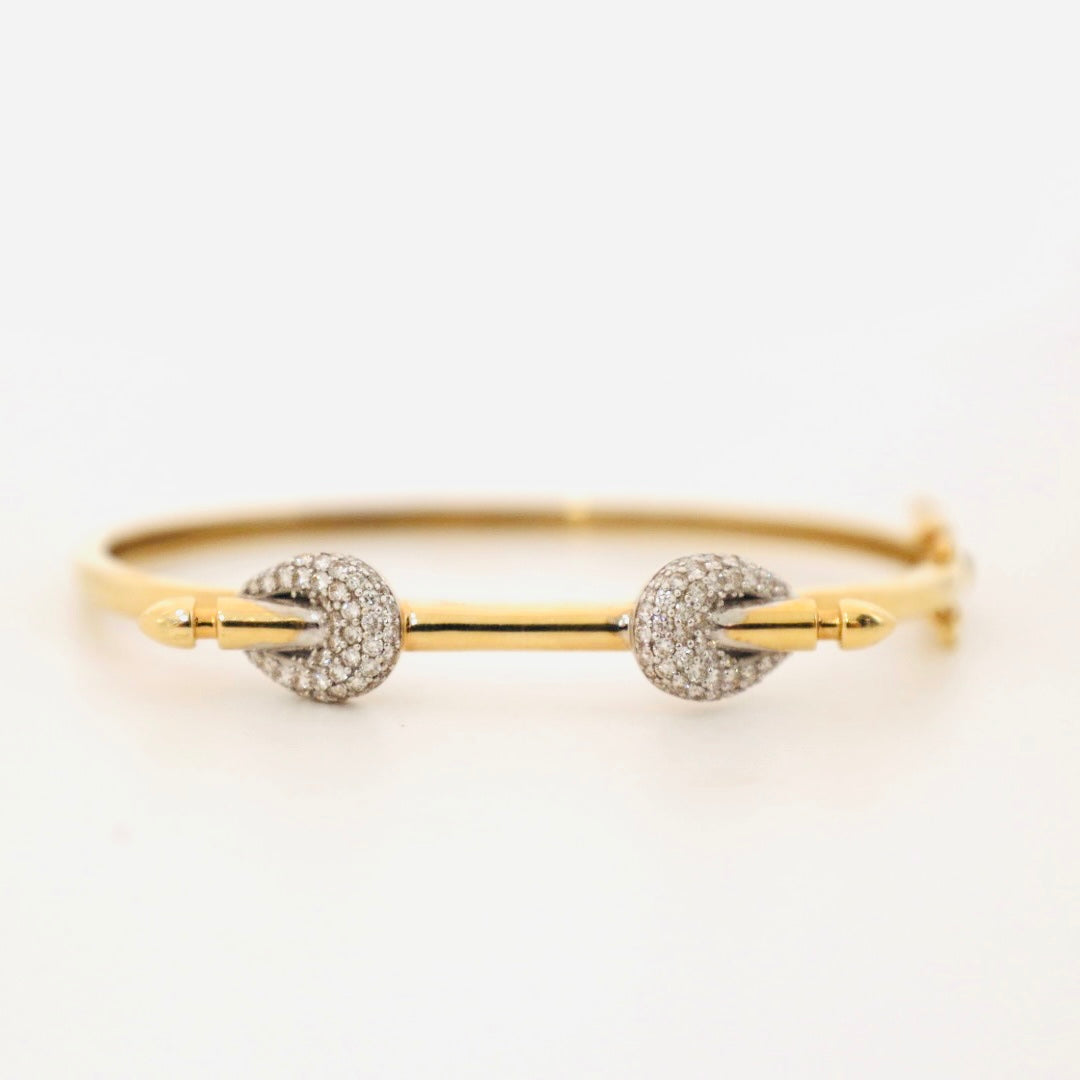 14k gold and baguette bangle with two diamond knots