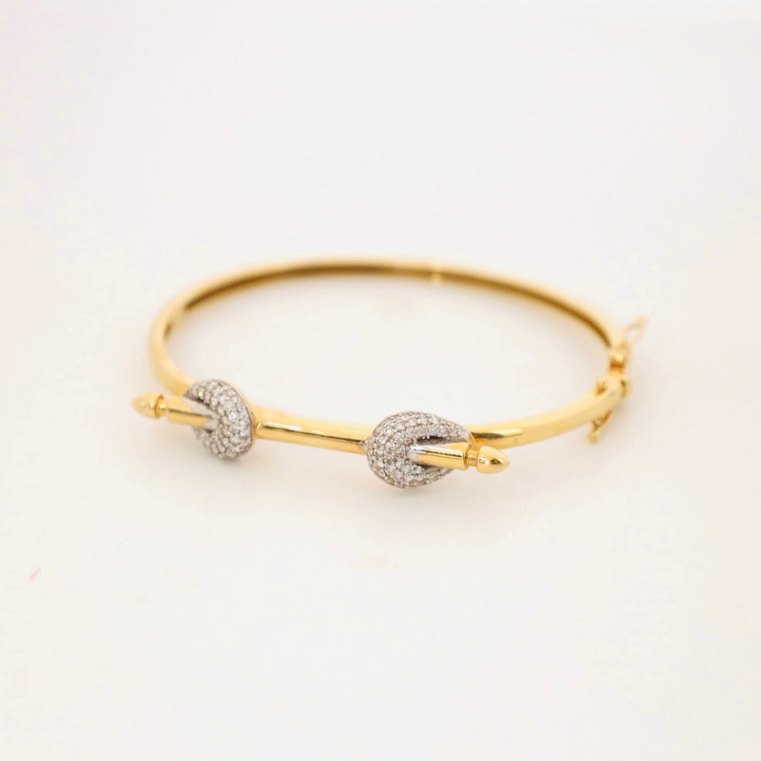 14k gold and baguette bangle with two diamond knots