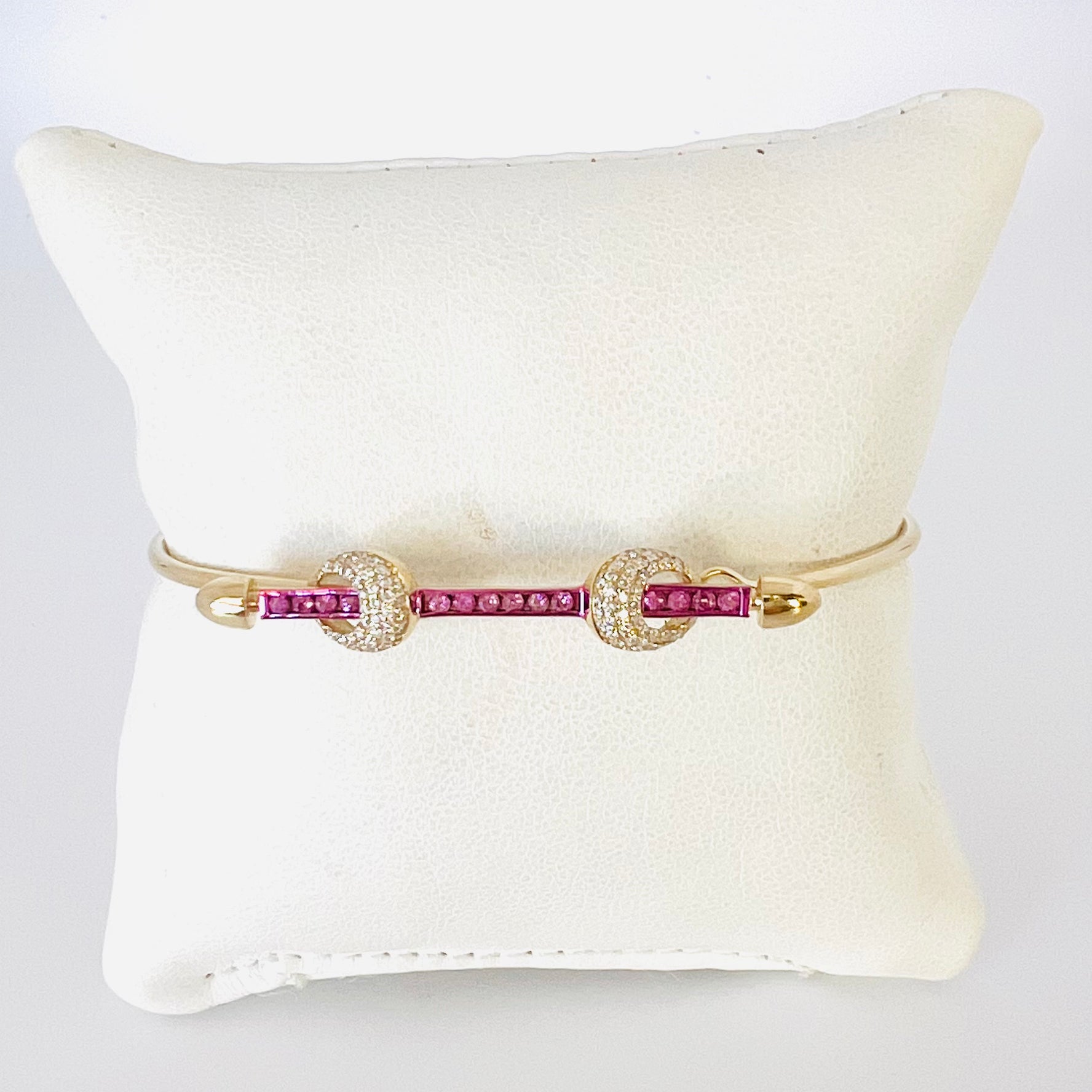 14k gold and baguette bangle with pink sapphire bar and two diamond knots