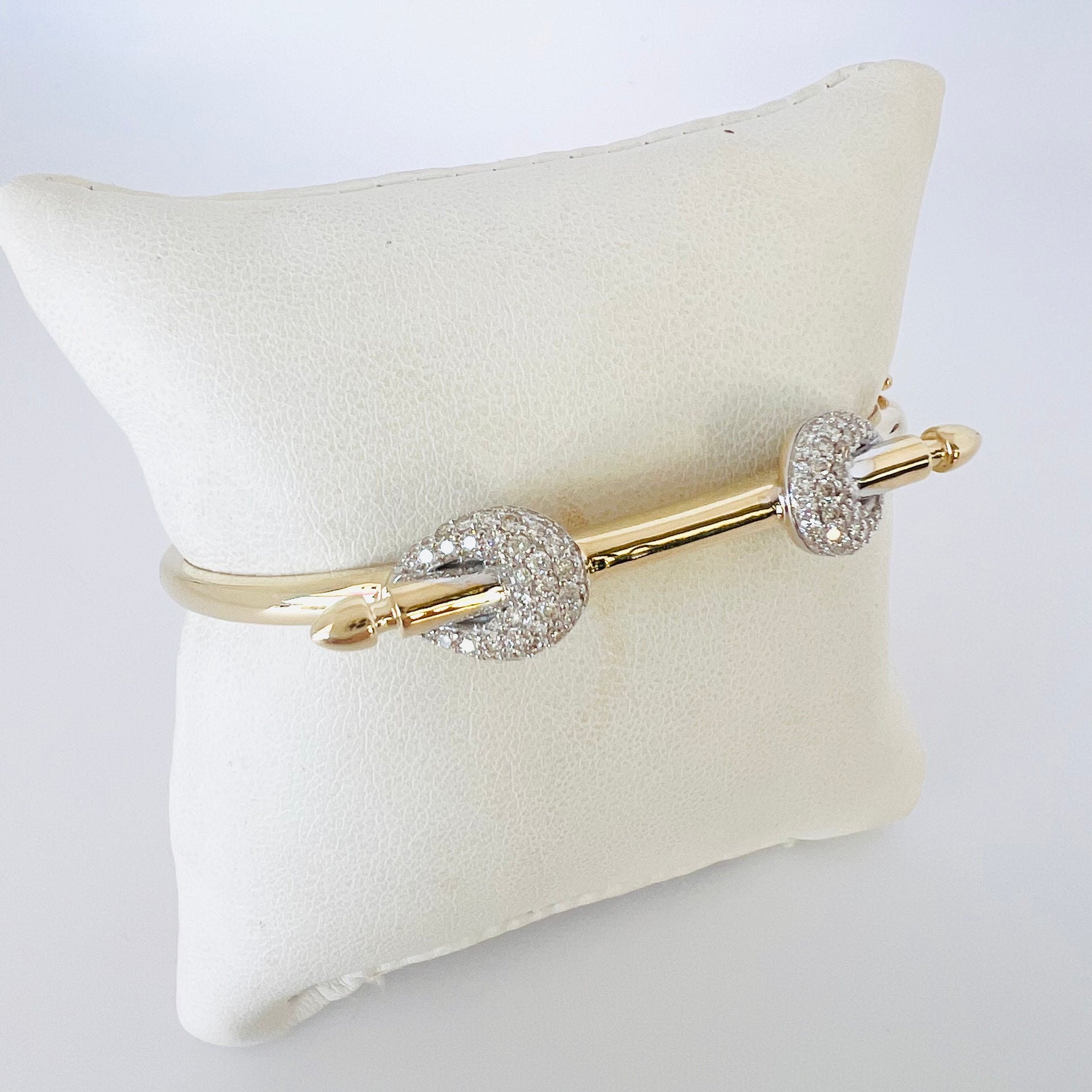 14k gold and baguette bangle with two diamond knots