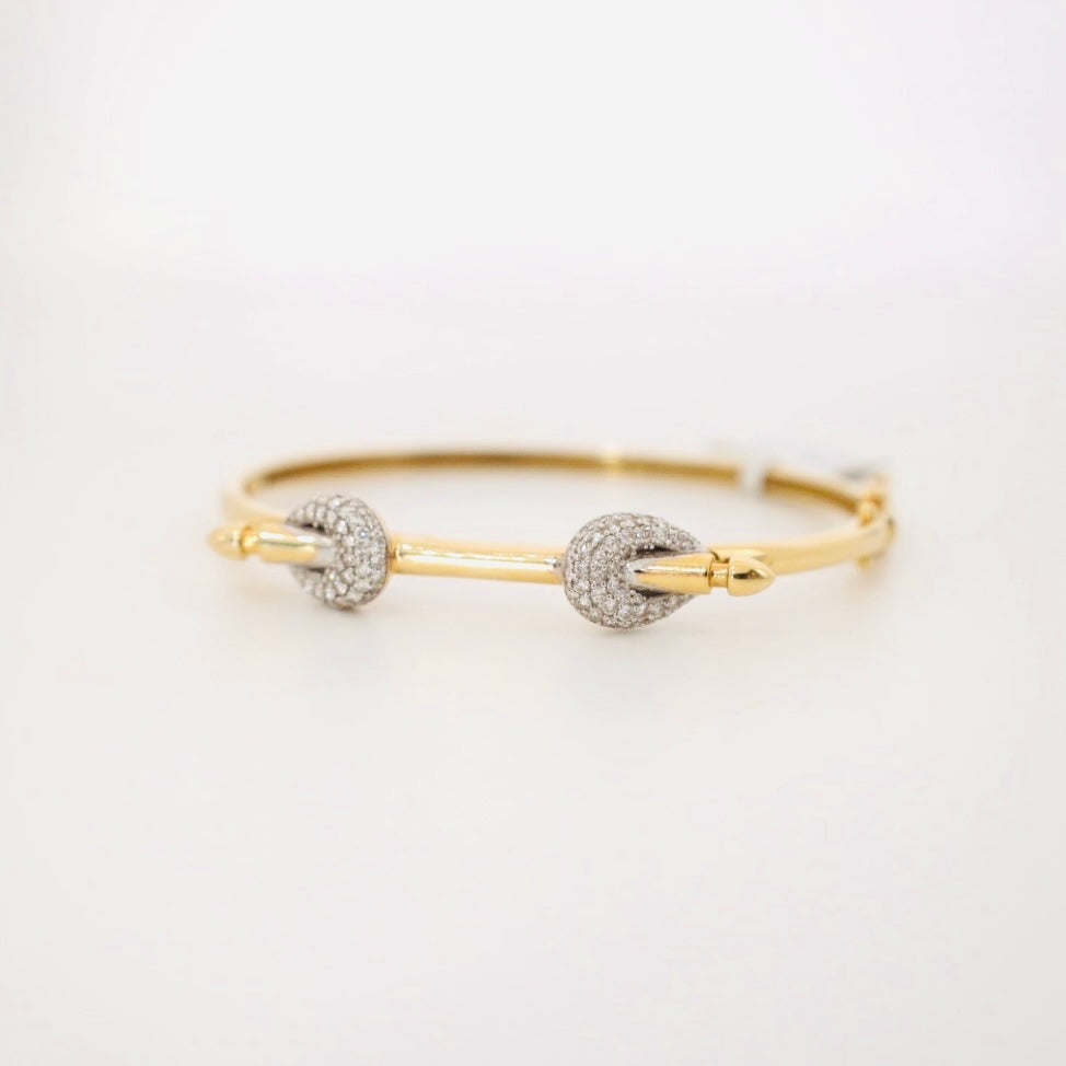 14k gold and baguette bangle with two diamond knots